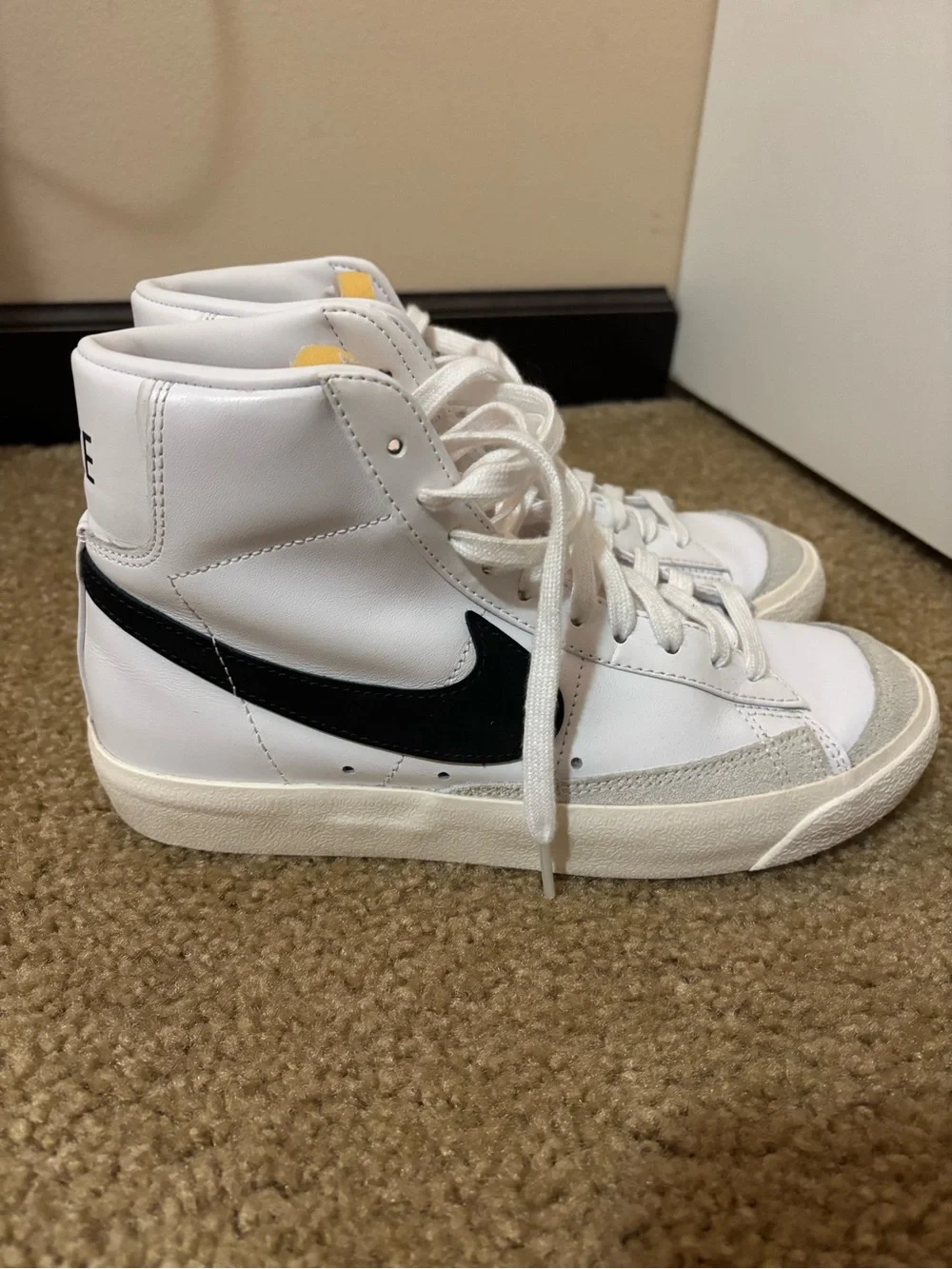 Nike White High-Top Sneakers with Black Swoosh and Yellow Tongue